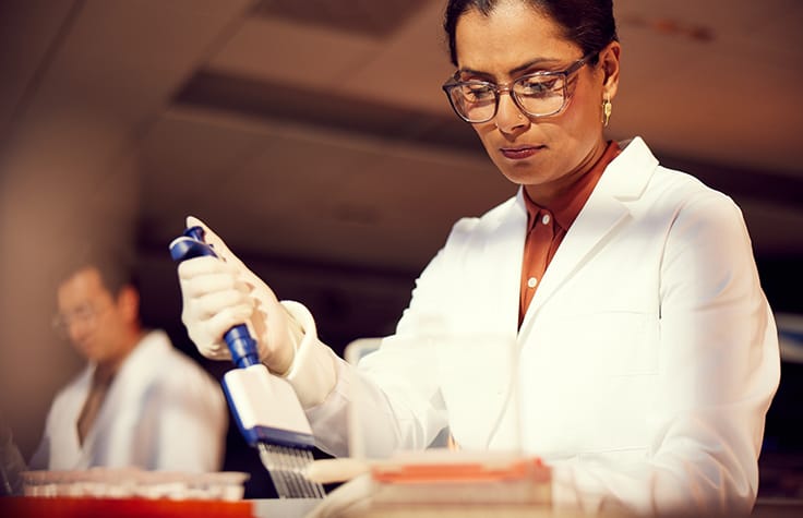 two people in lab using Illumina sequencer