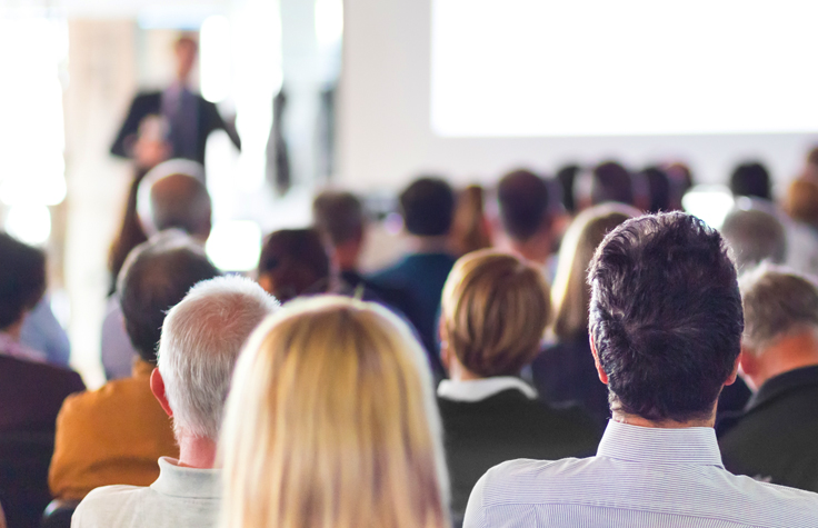 Image of a conference presentation from the audience perspective.