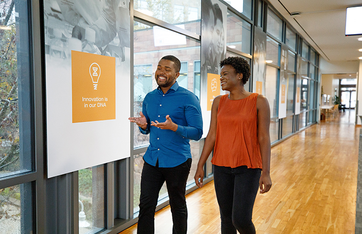 Illumina employees smiling in conversation 