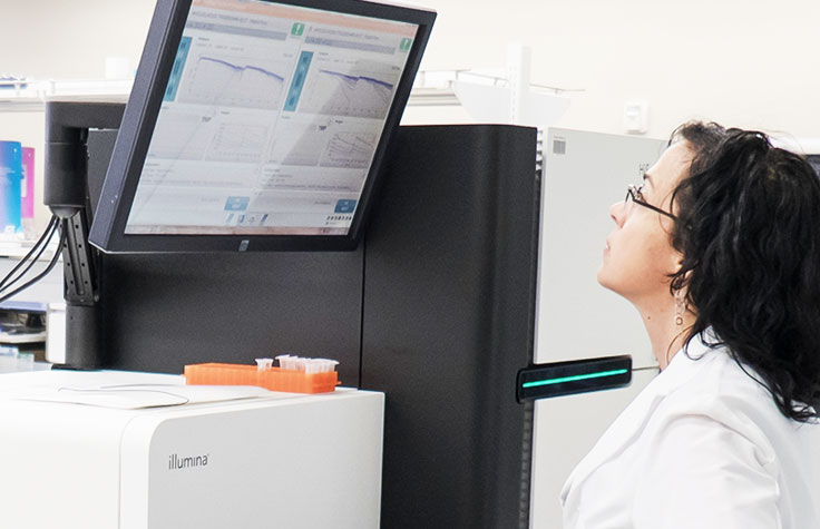 Scientist Looking up at HiSeq